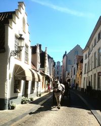 Street amidst buildings in city against sky