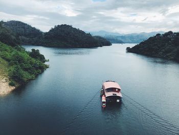 High angle view of river amidst trees against sky