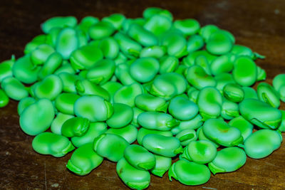 High angle view of green chili peppers on table