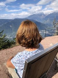 Rear view of woman looking at mountains