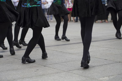 Low section of people walking on street