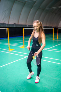 Portrait of young woman playing tennis