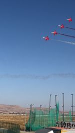 Low angle view of bird flying against clear sky