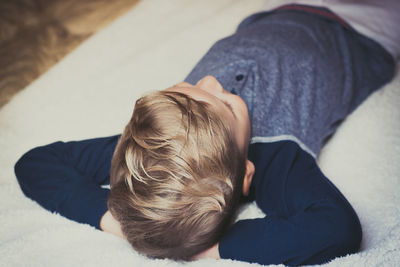 High angle view of boy sleeping at home