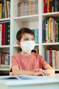 Portrait of boy reading book