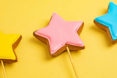 Directly above shot of gingerbread cookies on yellow background