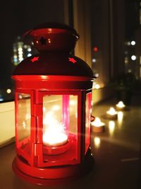 Close-up of illuminated lantern on table