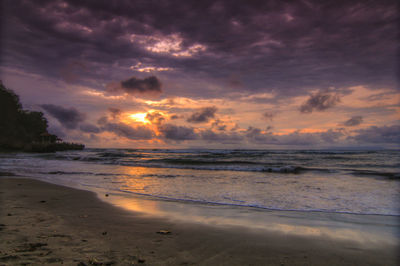 Scenic view of beach against sky during sunset