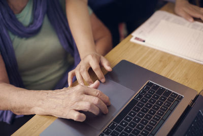 Hands of women using laptop