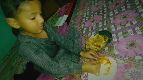 High angle view of girl holding flower