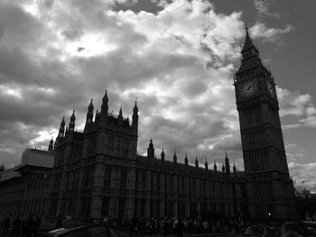 Low angle view of clock tower against cloudy sky