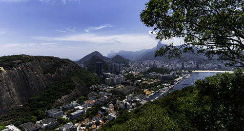 High angle view of townscape by mountain against sky