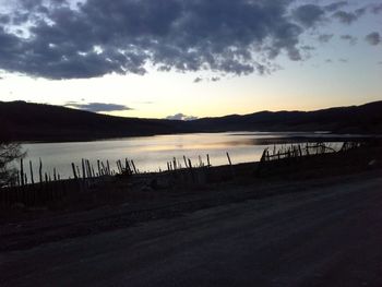 Scenic view of lake against cloudy sky