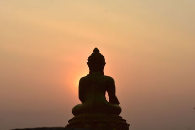 Low angle view of statue against sky during sunset