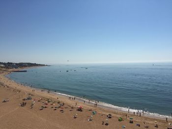 High angle view of people on beach against clear sky