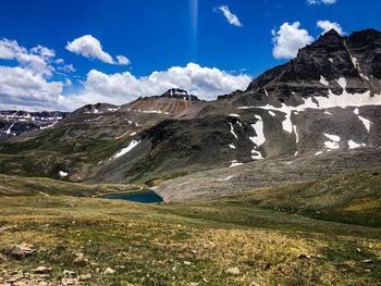 Scenic view of snowcapped mountains against blue sky