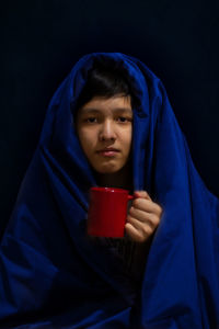 Portrait of mid adult man against black background