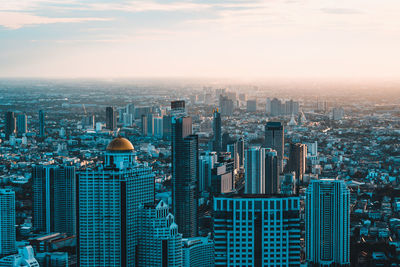 High angle view of modern buildings in city against sky