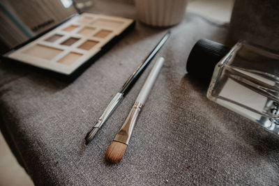 High angle view of beauty products on sofa