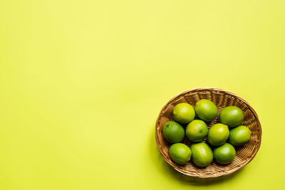 High angle view of grapes against yellow background