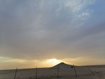 Scenic view of land against sky during sunset