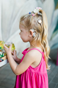 Side view of young woman drinking water