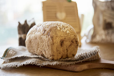 Sourdough organic unleavened bread with oatmeal on rustic sackling. loaf of natural freshly bread