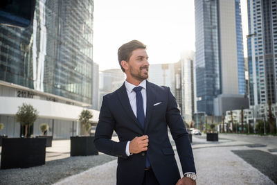 Businessman standing outdoors in city