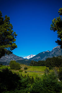 Scenic view of mountains against clear blue sky