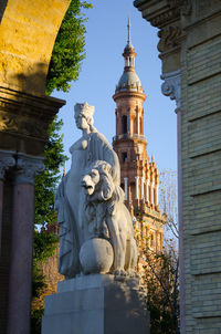 Low angle view of statue against historic building
