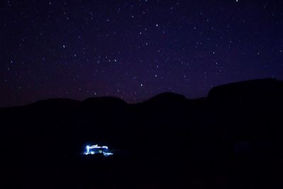 Scenic view of silhouette mountains against sky at night