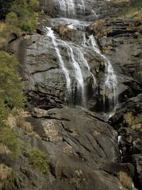 Scenic view of waterfall against sky