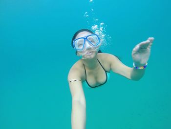 Portrait of young woman swimming underwater