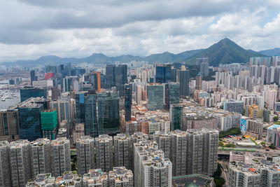 Aerial view of buildings in city against sky