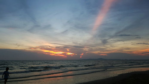 Scenic view of beach against sky during sunset