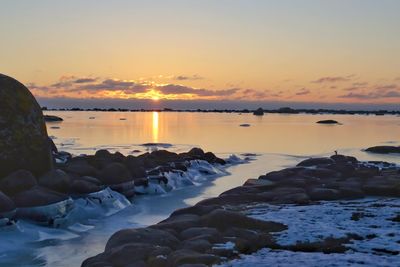 Scenic view of rocks against sky during sunset