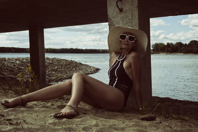 Portrait of young woman sitting at beach