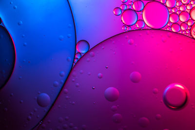 Close-up of water drops on pink glass