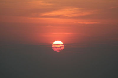 Scenic view of sea against orange sky