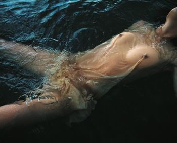 High angle view of woman swimming in sea