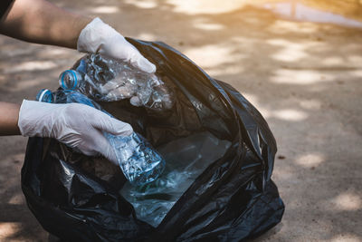 Close-up of hand holding plastic water