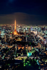 High angle view of city lit up at night