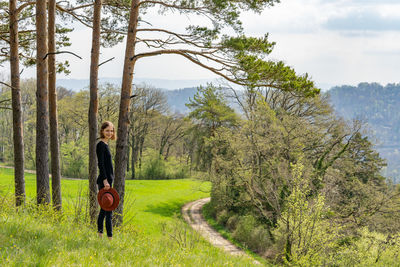 Rear view of woman walking on field