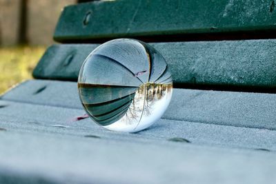 Close-up of crystal ball on frozen bench