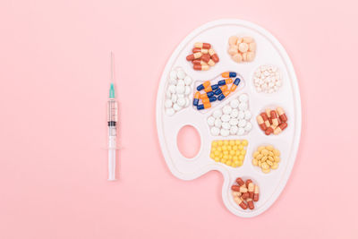 Directly above shot of multi colored candies against white background