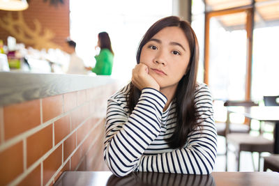 Portrait of young woman sitting outdoors