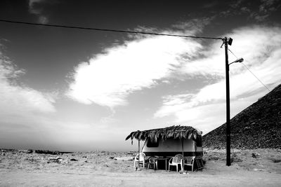 Lifeguard hut on beach against sky