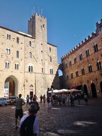 Group of people in historic building against clear sky