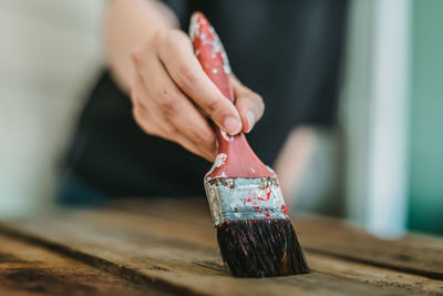 Close-up of person holding ice cream on table