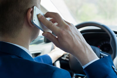 Close-up of man holding mobile phone